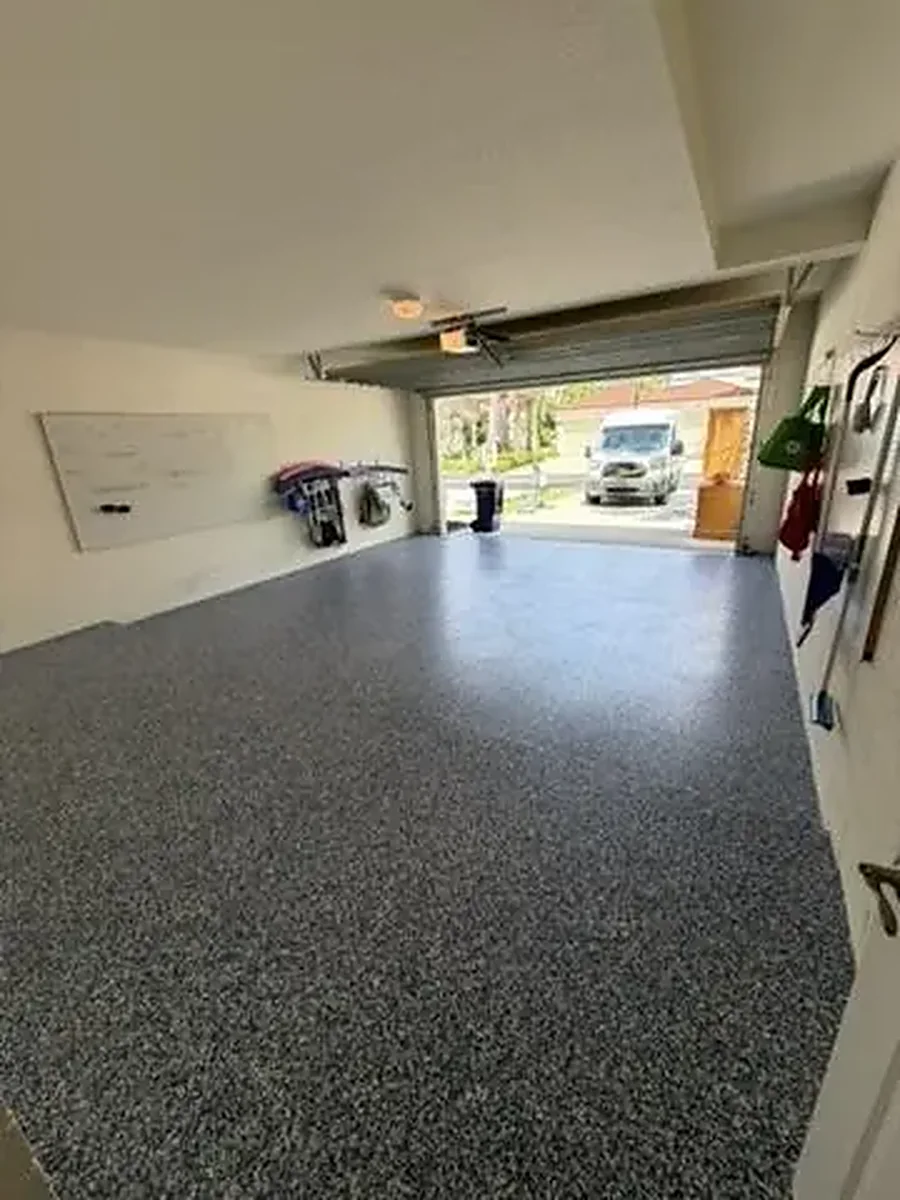 Finished epoxy garage floor with grey flake coating