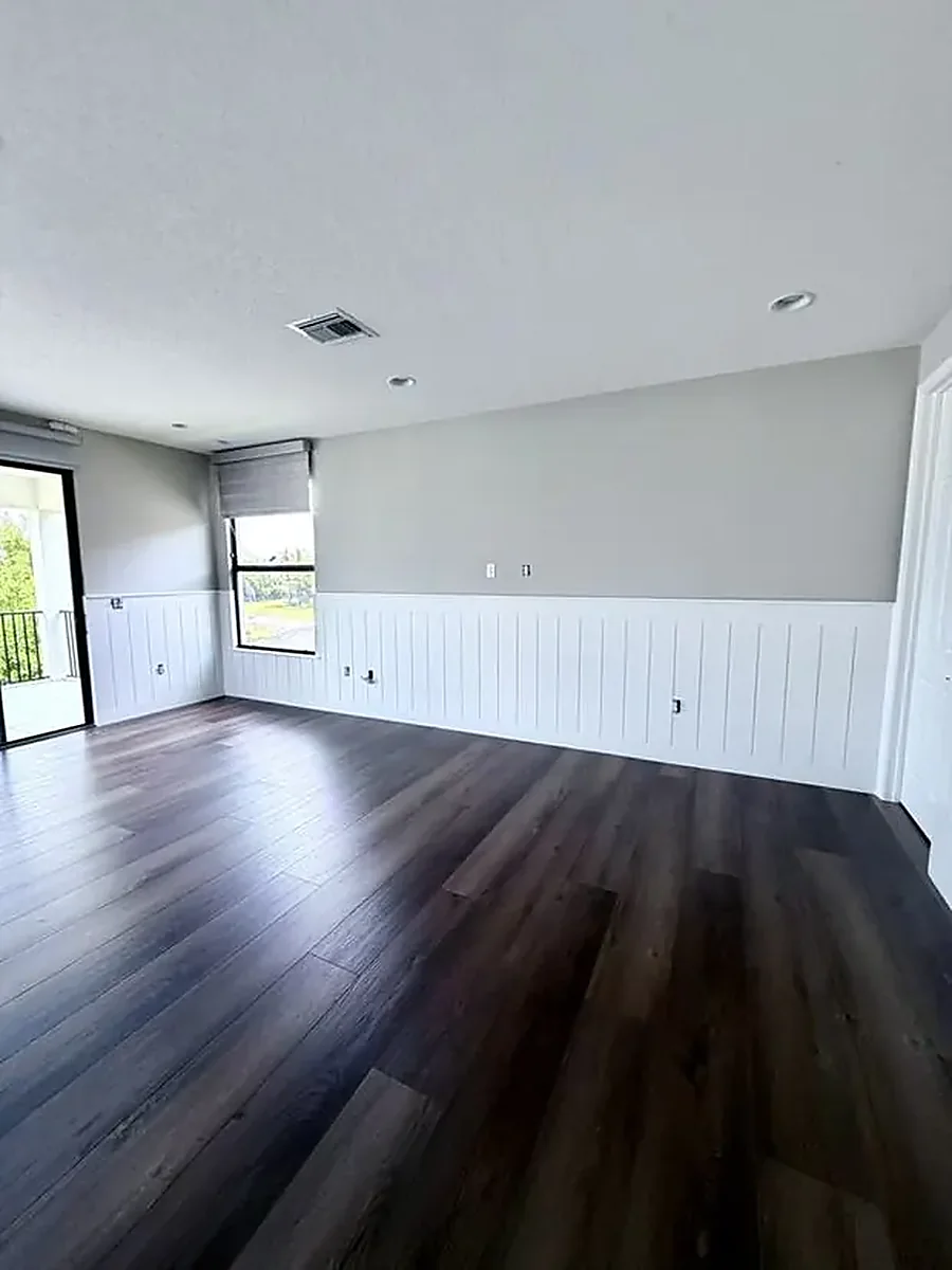 Finished living room with white wainscoting and grey walls